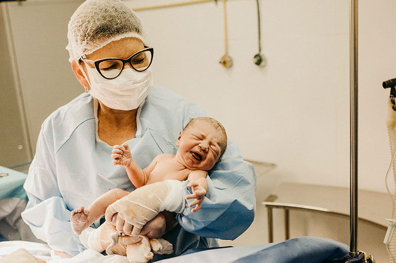 gynaecologist with new born baby